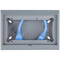 Gray wall-mounted enclosure with two blue network cables connected to ports on left and right sides, showing interior install