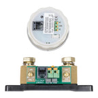 Victron BMV-712 battery monitor displaying internal components: circular white housing with circuit board and green terminal 