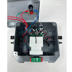 Interior view of rapid shutdown switch showing circuit board, white terminal blocks, red and blue wiring, and green-red indic