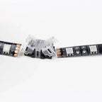 Clear connector clip between two sections of black LED strip with copper contacts, showing various pin configurations.