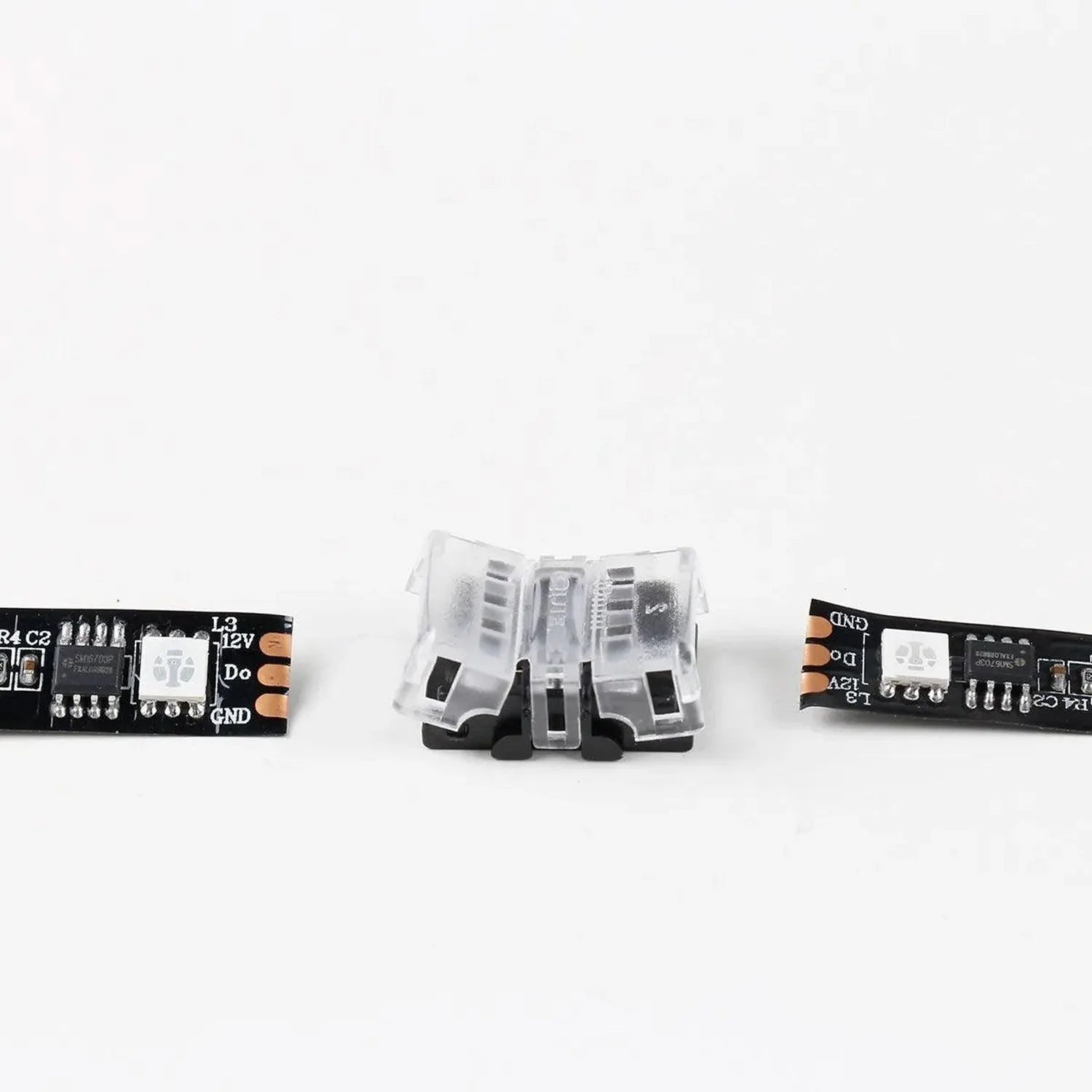 Transparent LED strip connector with two black circuit boards on either side, showing internal pin connectors and gold contac