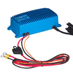 Blue rectangular battery charger with ribbed cooling fins, color-coded input cables and ring terminals, shown with power cord