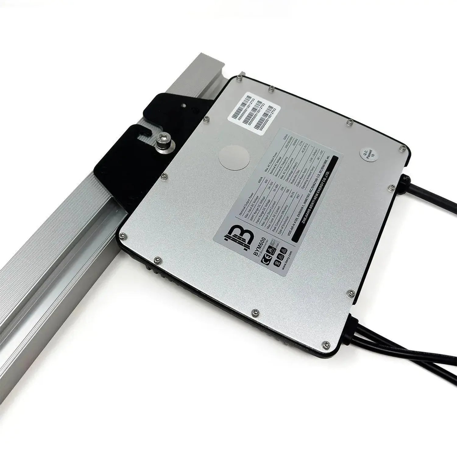 Silver rectangular microinverter with black connector mounted on aluminum rail, showing regulatory labels and specifications 