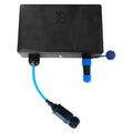 Black rectangular Ethernet gateway device with three blue and black cable connectors shown from above, installation shot.
