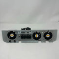 Gray metal cooling fan assembly with three black axial fans and central terminal block mounted on white background.