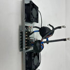 Cooling fan assembly mounted on vertical metal frame with dual black axial fans, blue wiring harness, and circuit board with 