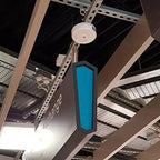 LED emergency spot light mounted on ceiling infrastructure with blue vertical panel and white circular fixture.