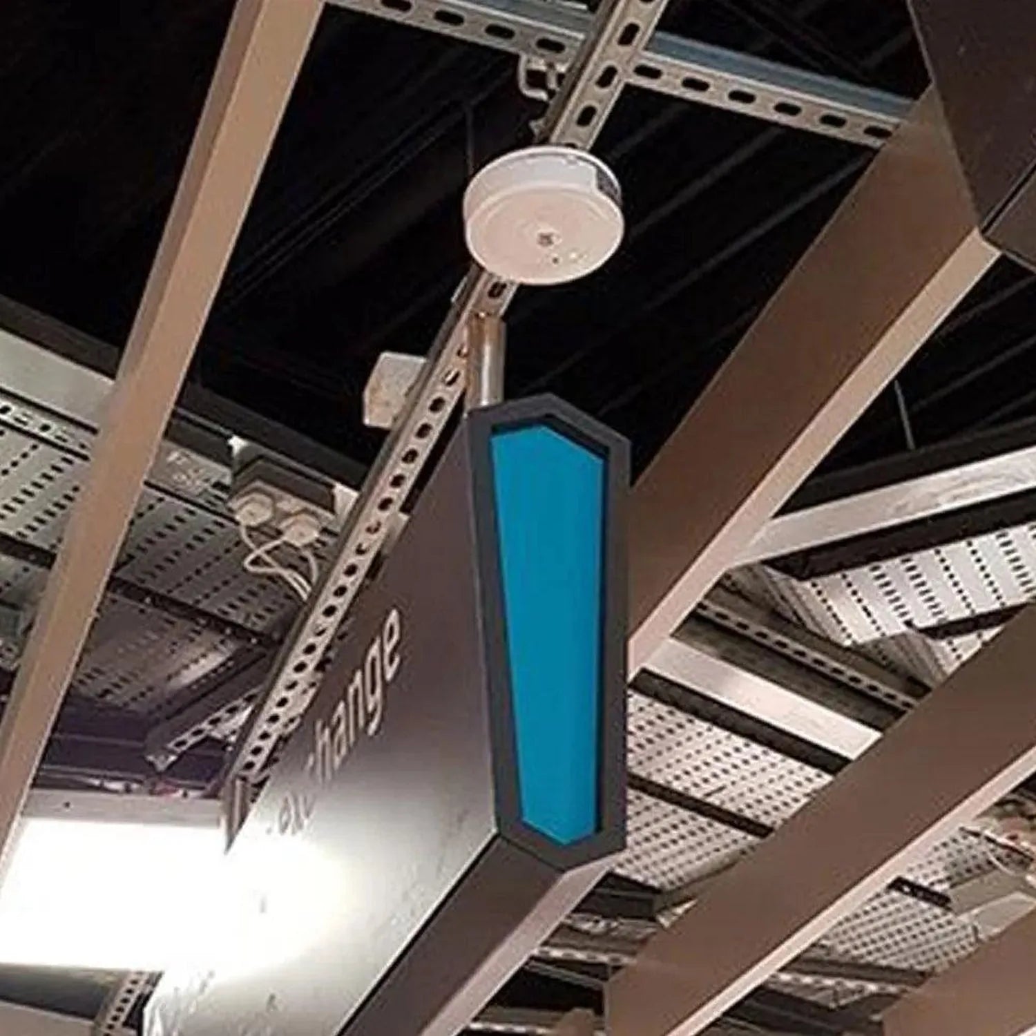 LED emergency spot light mounted on ceiling infrastructure with blue vertical panel and white circular fixture.