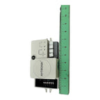Hytronik daylight sensor photocell switch displayed next to green ruler showing approximately 3 inches in height, with termin