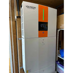 Voltagon Energy Systems 5.5kW all-in-one home battery storage unit installed in residential setting, white casing with orange
