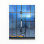 Back view of Elite 455W bifacial solar panel showing wiring connectors and junction box against blue sky reflection.