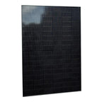 Black bifacial solar panel with vertical ribbed texture and light reflection visible on upper left corner, shown at angle aga