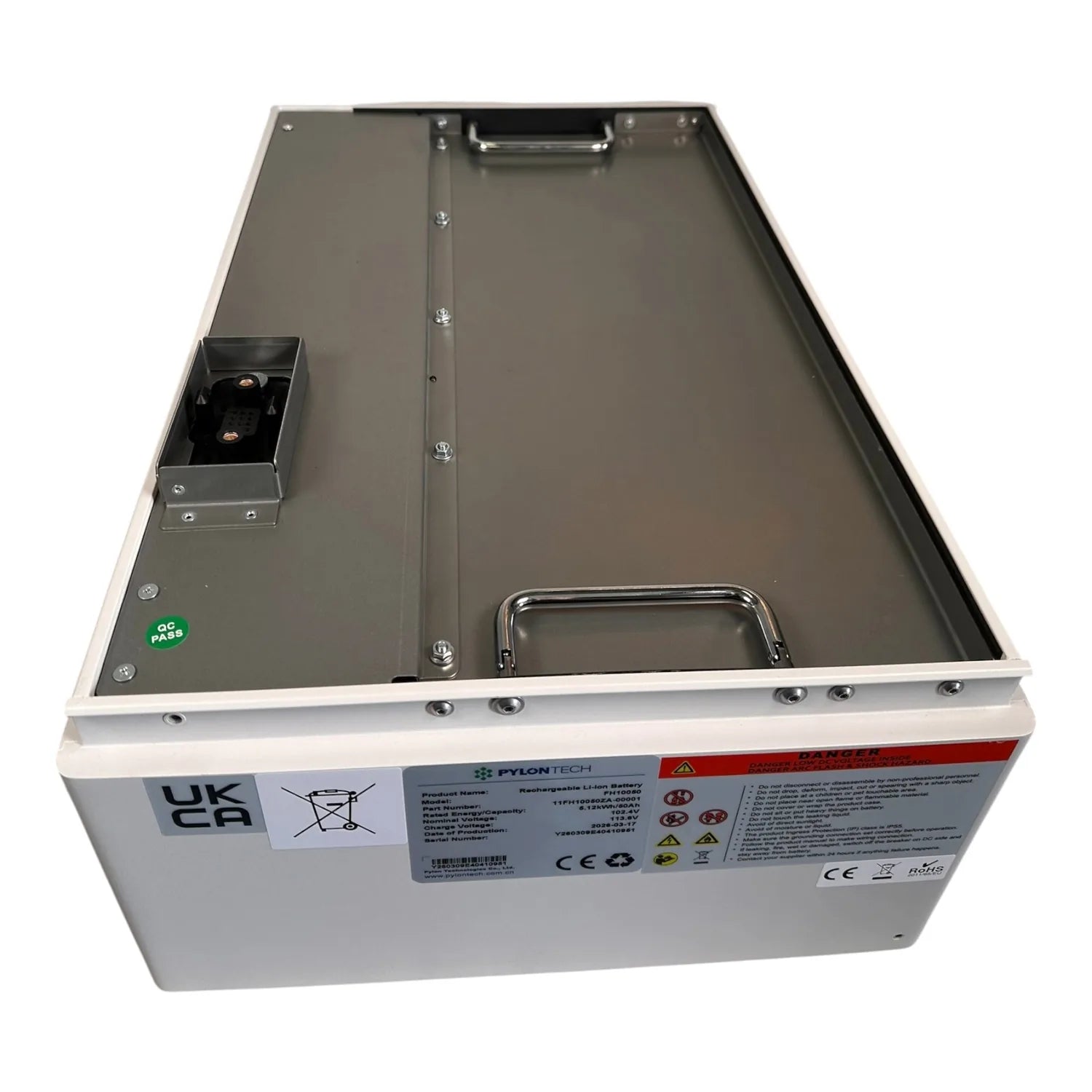 Open top view of Pylontech lithium battery module showing interior compartment with terminal connectors and safety labels on 
