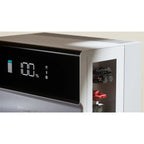 Pylontech Force H3X hybrid solar inverter displaying 100% battery charge on digital screen with storage compartment containin