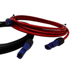 Red and black solar PV extension cables with blue Amphenol connectors coiled together against white background.