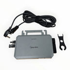 Hoymiles 800W solar microinverter kit with gray junction box, power cord, MC4 connectors, and mounting bracket laid flat on w