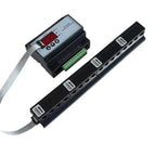 Solar PV string current monitor with display unit connected via ribbon cable to four black sensor modules mounted on DIN rail