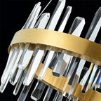 Gold and crystal LED ceiling pendant light with stacked clear crystal rods and brass bands against black background, product 