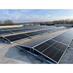 Rooftop solar panel installation showing multiple black solar panels mounted on flat concrete roof with white metal ballast f