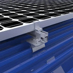 Klip-Lok 406 solar panel mounting clamp installed on blue corrugated metal roof with black solar panels above, showing instal
