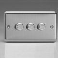 Brushed steel 3-gang dimmer switch with three rotary dials and mounting holes on left and right sides.
