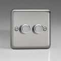 Brushed steel two-gang dimmer switch with two rotary controls and mounting screws on gray background.