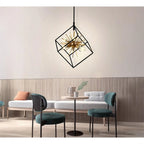 Astral LED pendant light with geometric black frame and brass starburst element, installed in modern lounge setting above din
