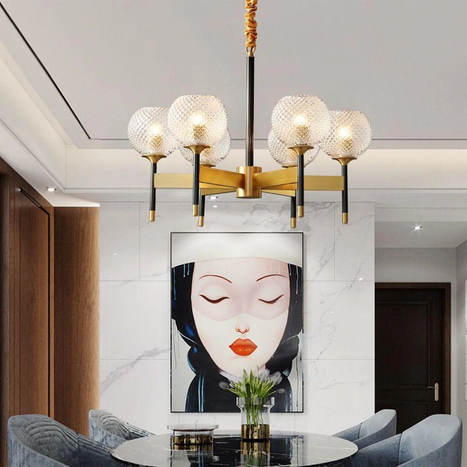 Six-way pendant ceiling light with textured glass shades, brass and black metal frame, installed above round table in modern 