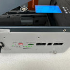LiFePO4 battery unit showing front control panel with blue LCD display, reset button, dry contact terminals, RS485 and RS232 