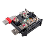 Victron Lynx Shunt battery monitor showing internal components with multiple silver terminal posts, red fuses, green circuit 
