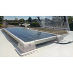 Rooftop solar panel installation on RV with white mounting brackets and gray storage compartment visible.