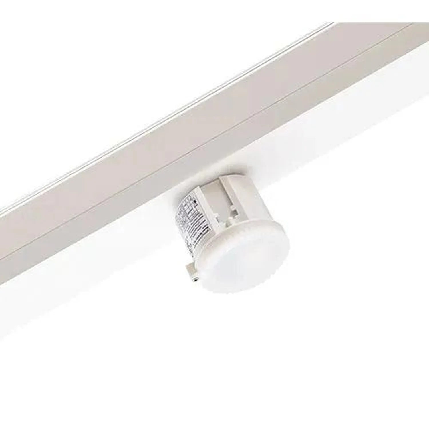 White cylindrical daylight sensor mounted on aluminum track rail against white ceiling.