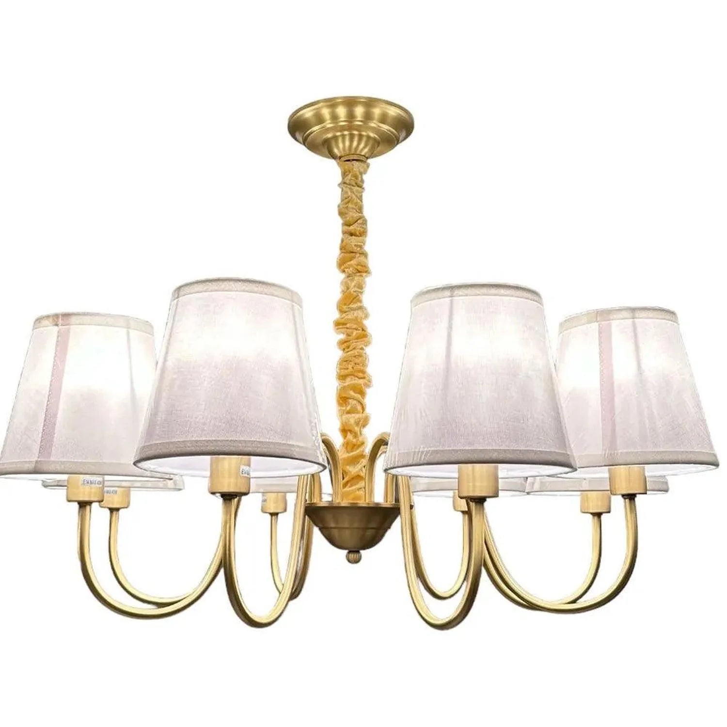 Brass chandelier with eight curved arms, twisted rope stem, and cream linen shades against white background.