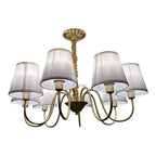 Gold chandelier with six fabric lampshades and curved brass arms, shown against white background.