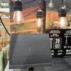 Solar panel and product packaging for Artika Eclipse solar string lights with 20 LED bulbs, displayed in retail setting.