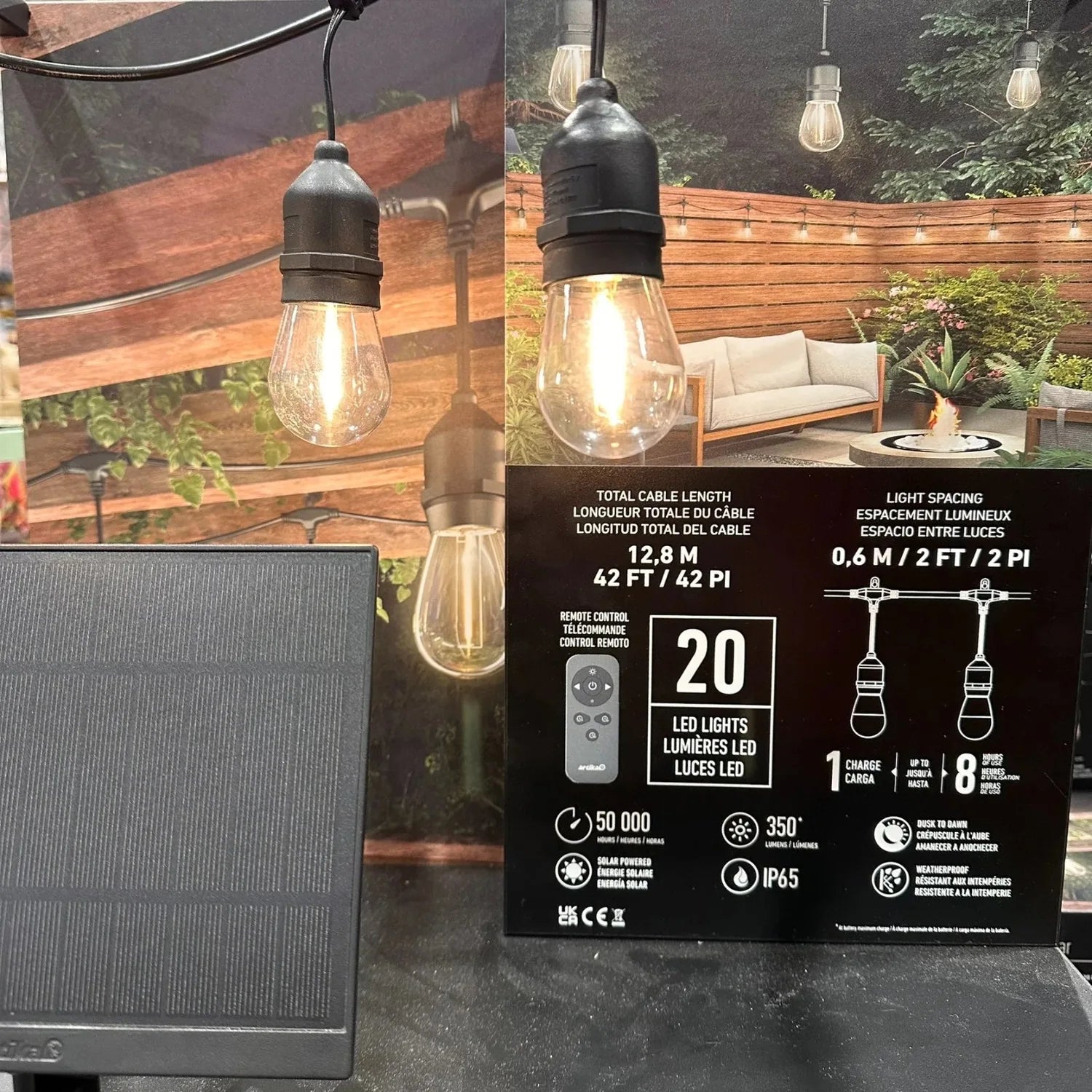 Solar string lights packaging with product specifications, remote control, and installation photos showing warm LED bulbs str