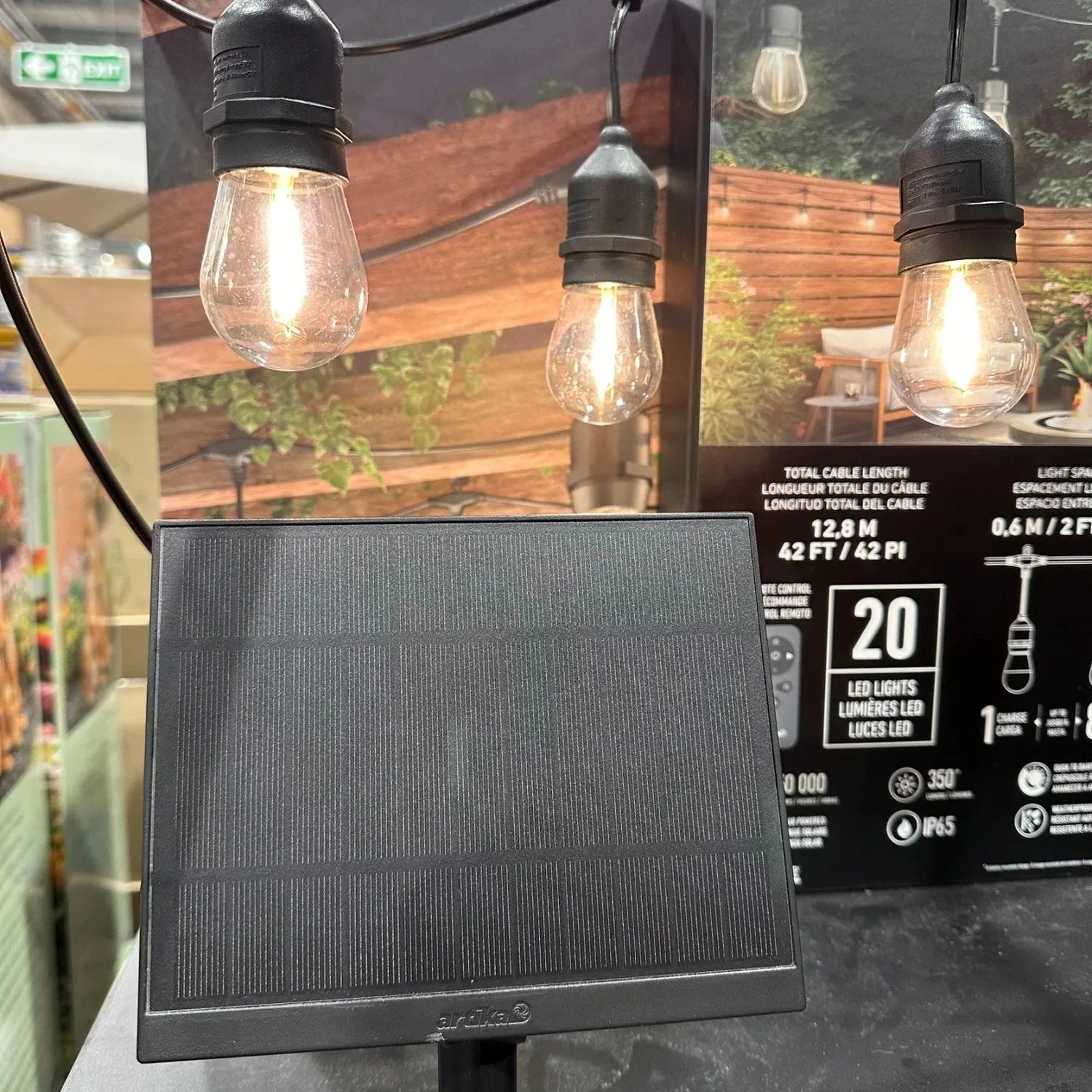 Solar panel with attached cable for Artika Eclipse string lights, displayed next to product packaging showing 20 LED lights.