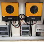 Two Voltacon Energy Systems inverters mounted on wall above monitoring equipment and electrical panels in solar installation 