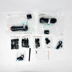Unboxed components of Solis hybrid inverter system, including black cylindrical connectors, cable fittings, small black plast