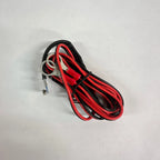 Coiled red and black electrical cable with connector terminal on white background.