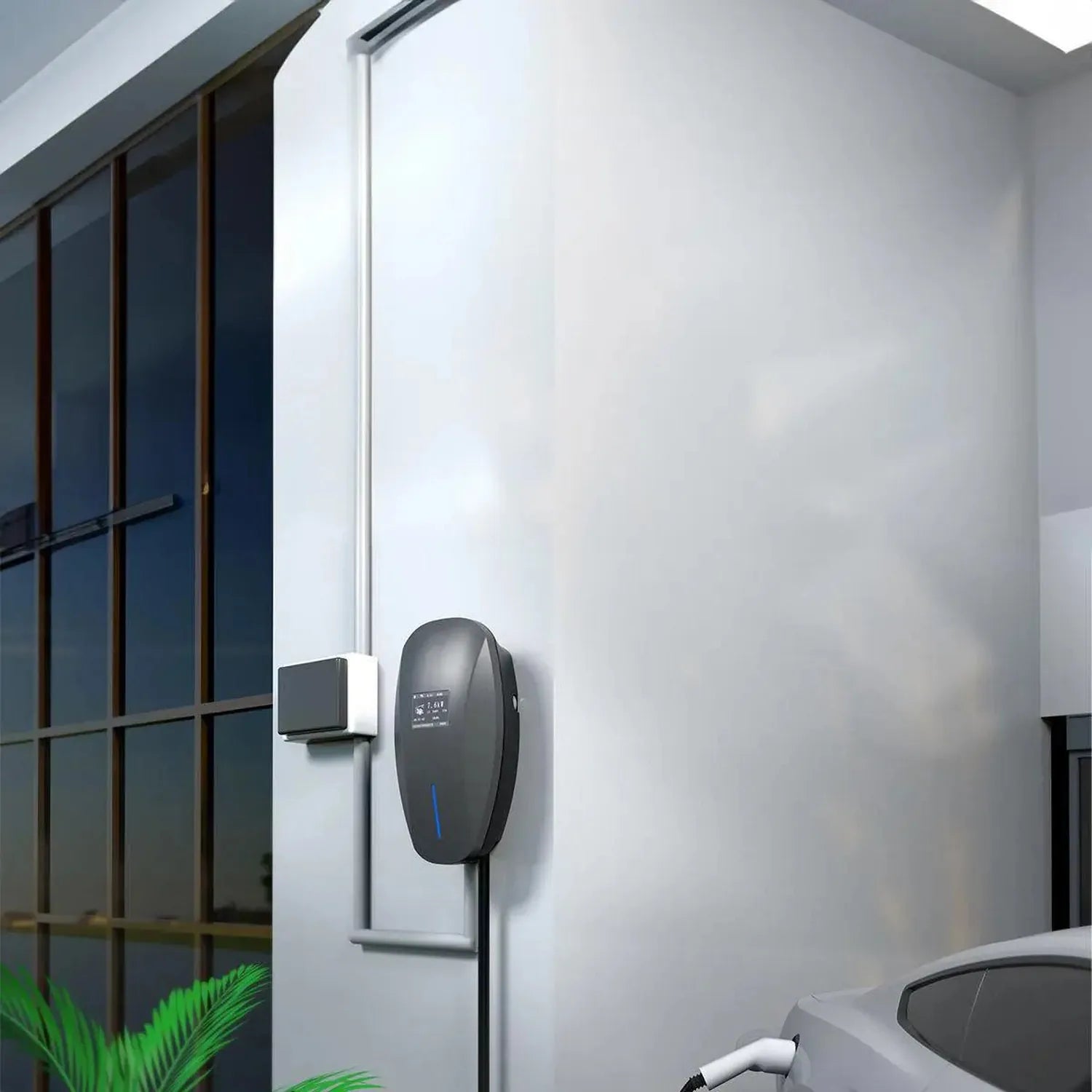 Black wall-mounted EV charger installed on white exterior wall next to gridded window and charging cable below.