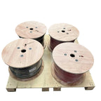 Four wooden cable drums on wooden pallet, two containing black wire and two containing red wire