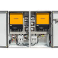 Two open Voltagon energy systems cabinets showing yellow inverters, circuit breakers, wiring, and control components installe