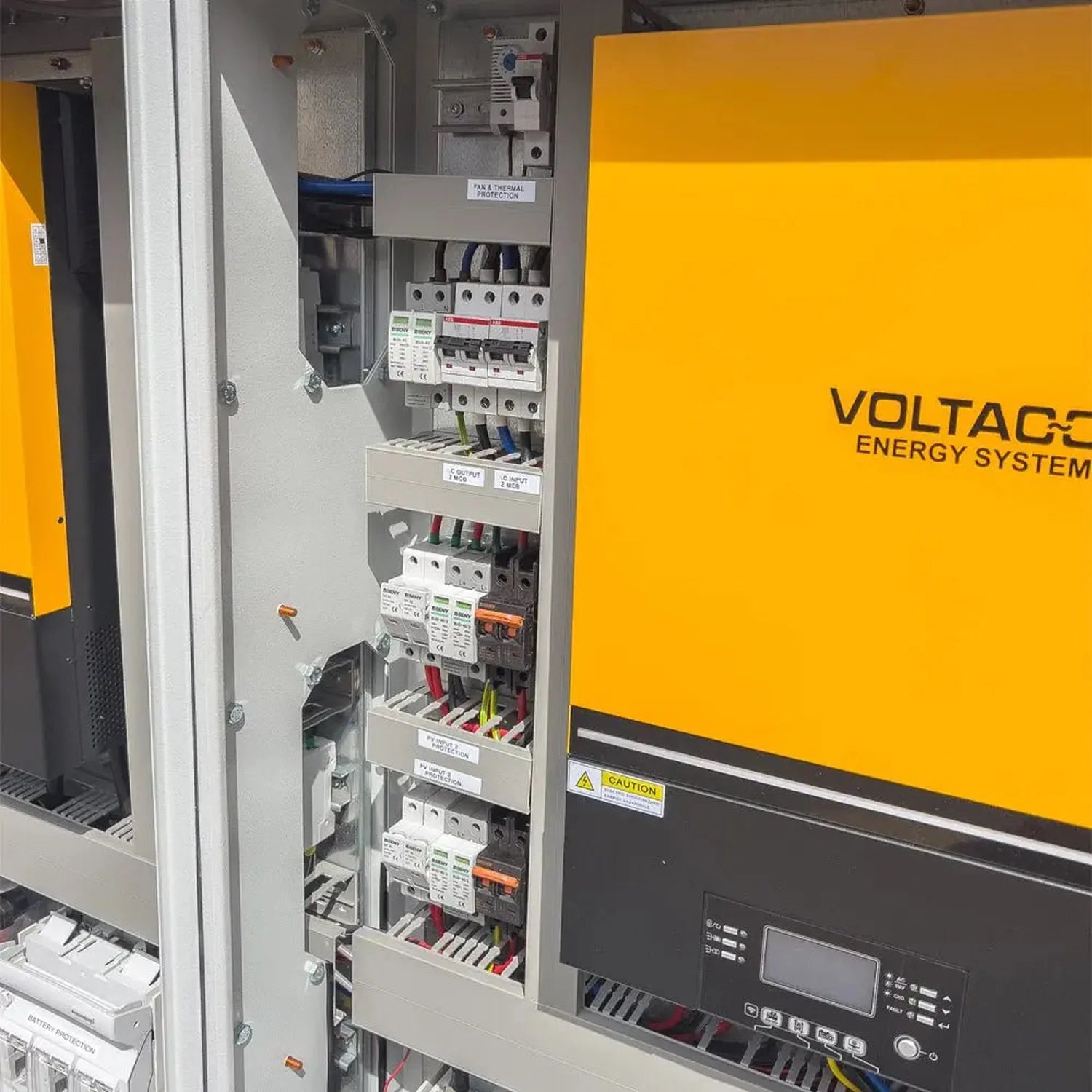 Voltage Energy System 16kW off-grid solar control cabinet with open door showing internal circuit breakers, terminals, and wi