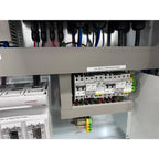 Interior installation shot of solar control cabinet showing PV input protection section with circuit breakers and yellow-gree