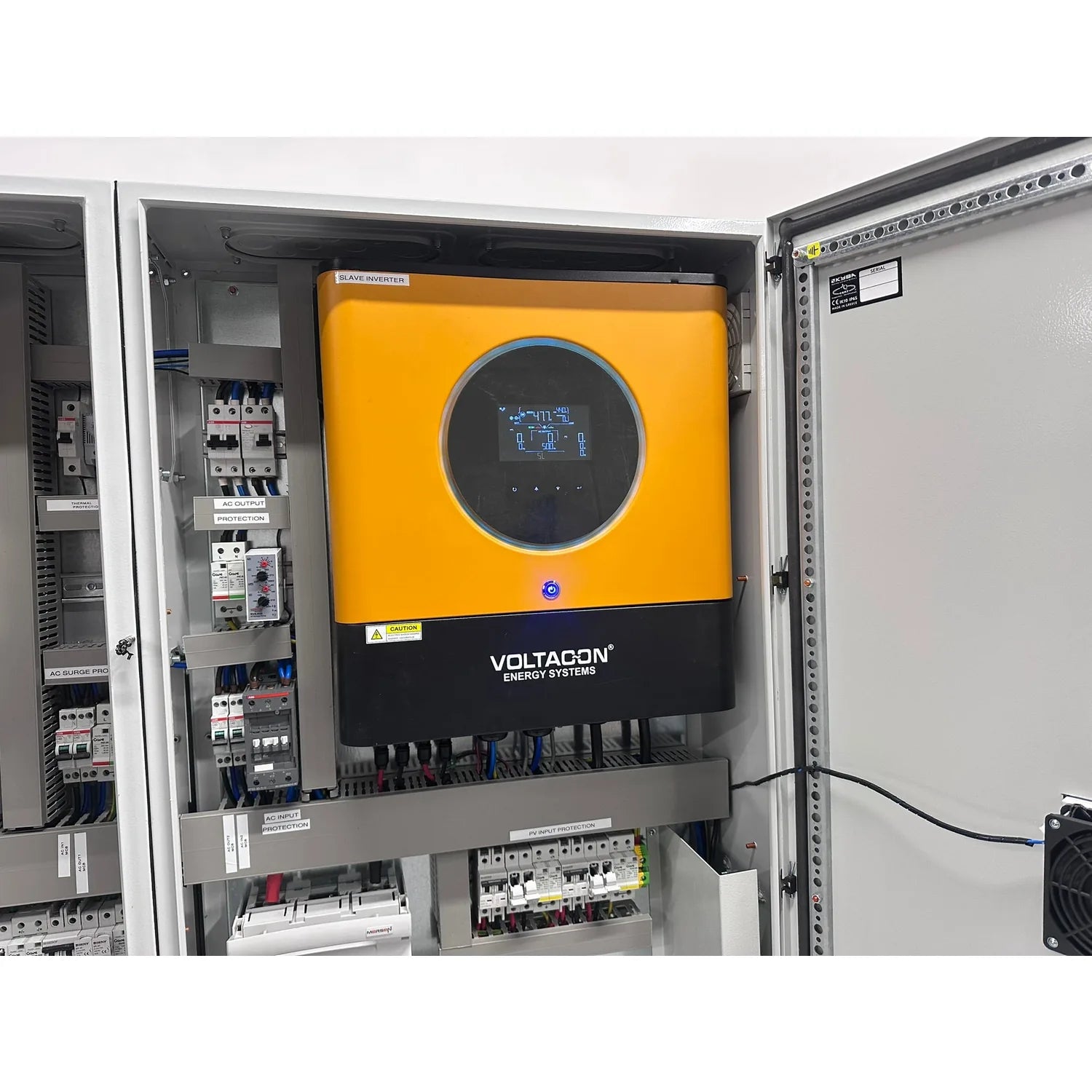 Voltacon Energy Systems solar inverter installed in white cabinet with yellow and black control unit, electrical components, 