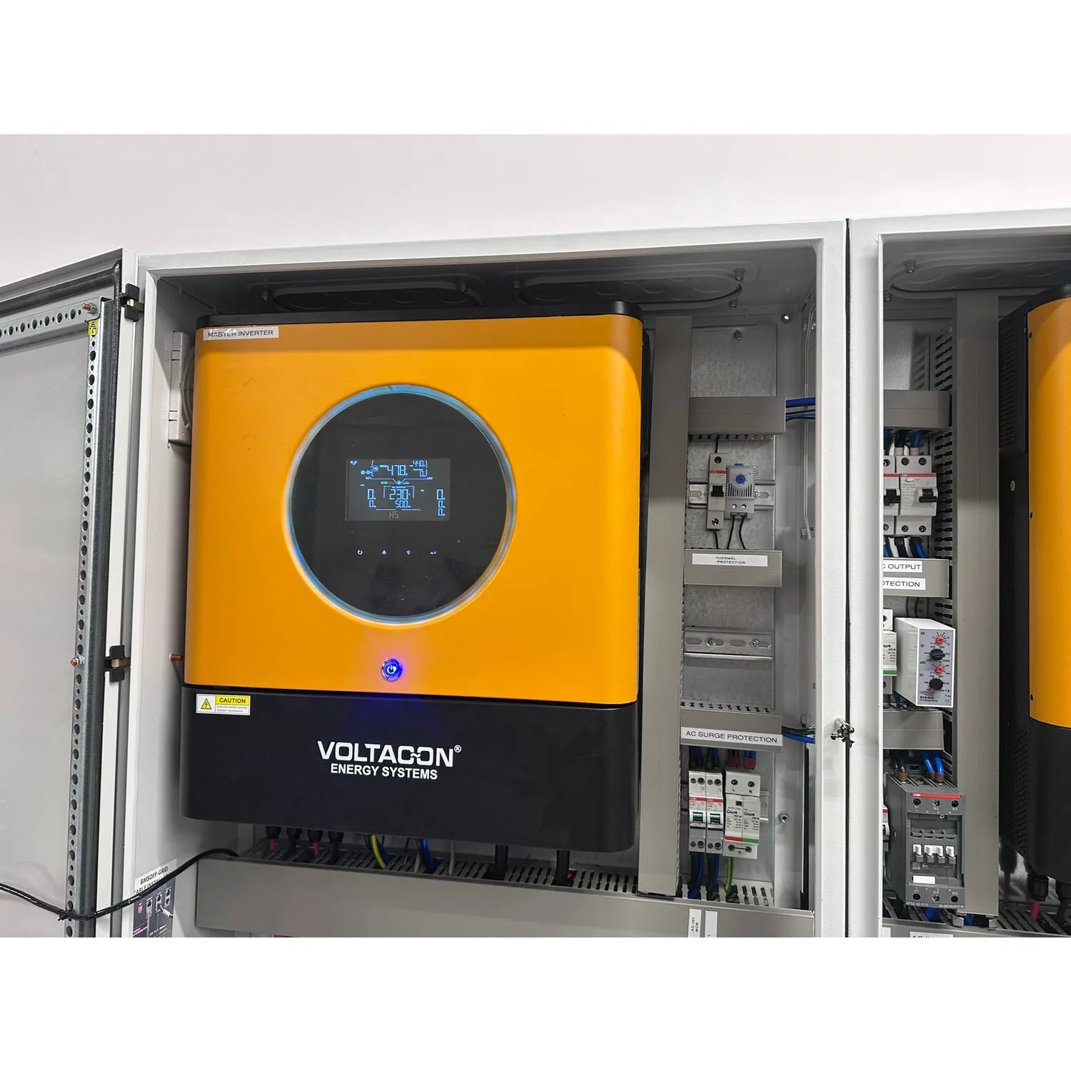 Voltagon Energy Systems 22kW solar inverter cabinet installed in wall-mounted enclosure with yellow front panel and digital d