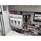 Interior installation view of off-grid solar control cabinet showing battery protection module, terminals, circuit breakers, 