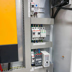 Interior installation view of off-grid inverter cabinet showing circuit breakers, surge protection devices, AC relay, and vol