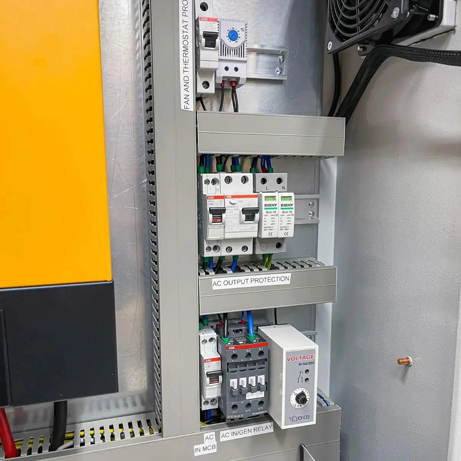 Interior installation view of off-grid inverter cabinet showing circuit breakers, surge protection devices, AC relay, and vol
